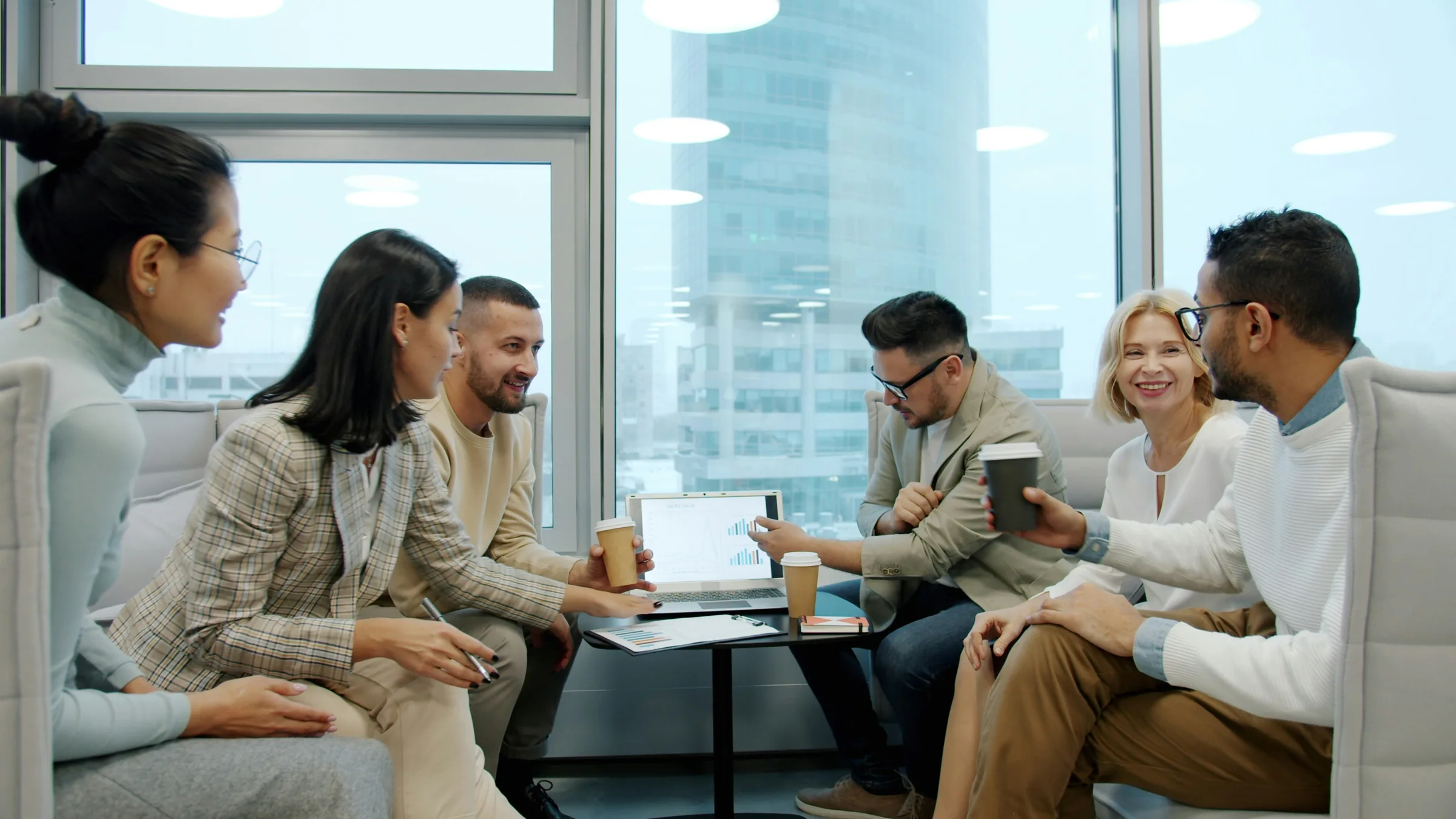 A diverse business team discussing a presentation in a modern office